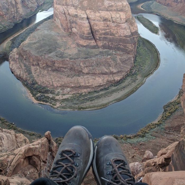 A person relaxing on a canyon ledge while sporting these shoes.
