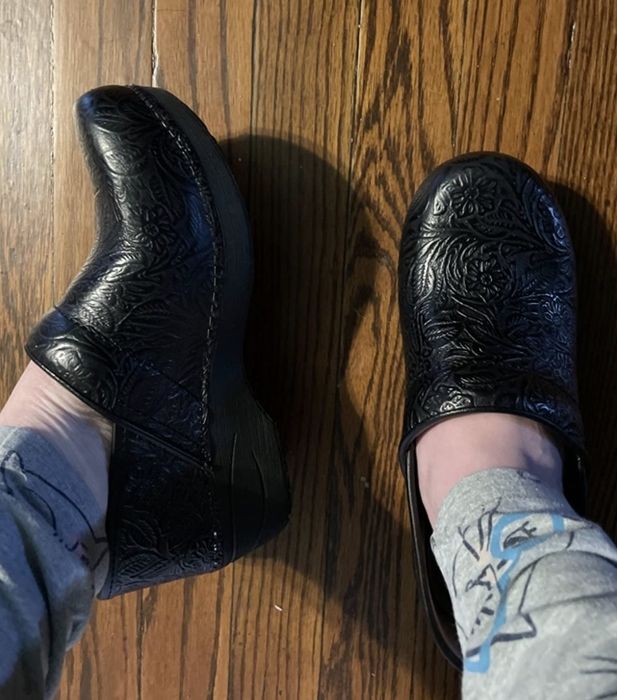 A reviewer showing off the clogs in a paisley pattern.