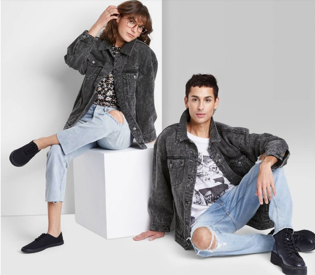 Models rocking matching vintage black denim jackets with ripped blue jeans and black sneakers.
