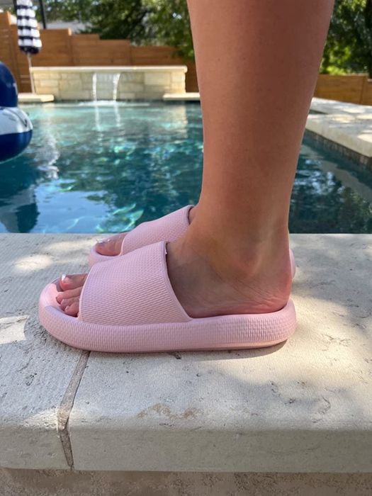 A reviewer rocking the pink slide sandals.