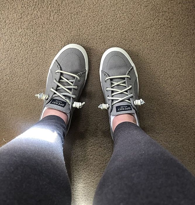A reviewer sporting the gray Sperry sneakers.