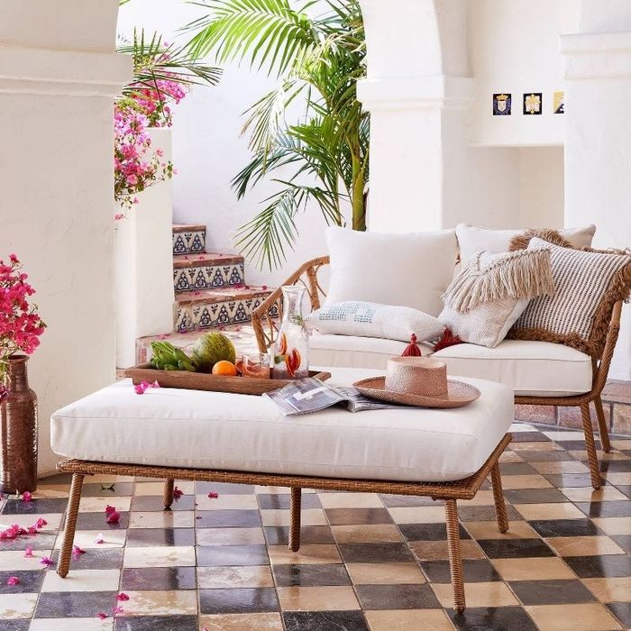 The ottoman positioned in front of the matching loveseat.