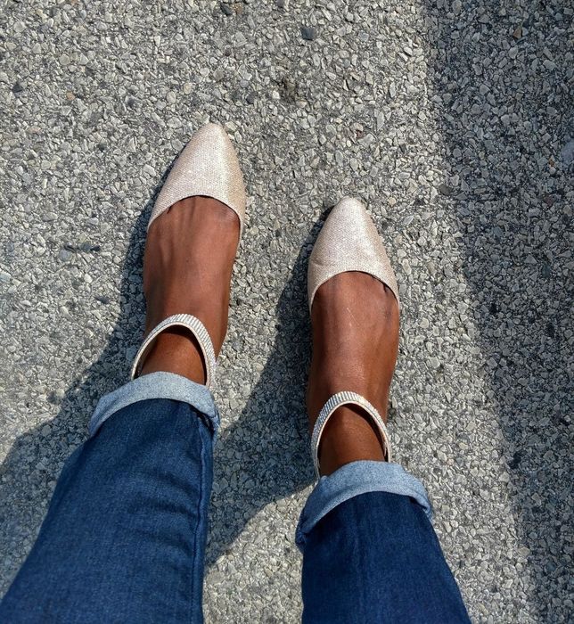 A picture of a reviewer wearing beige glittery flats.