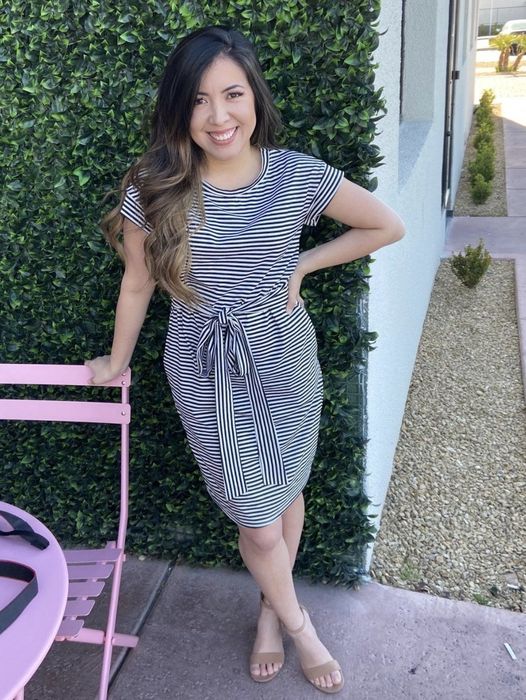 Reviewer showcasing a striped dress