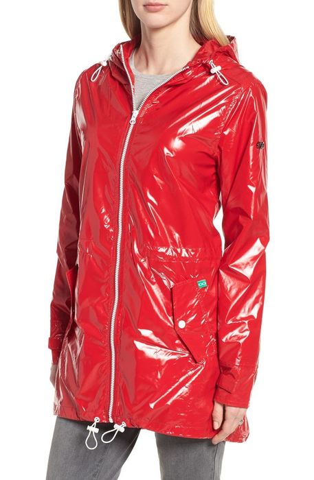 model showcasing a shiny red nylon raincoat