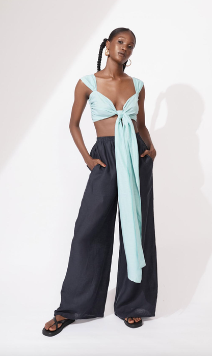 Model wearing navy linen trousers