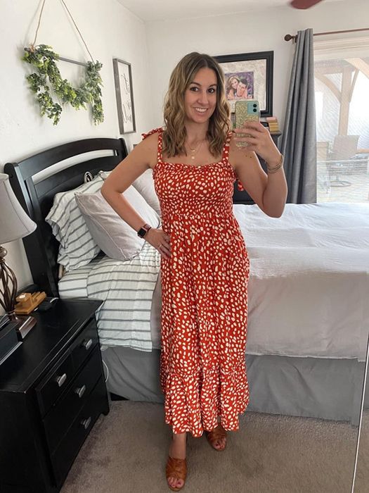Reviewer wearing a playful red and white polka dot dress