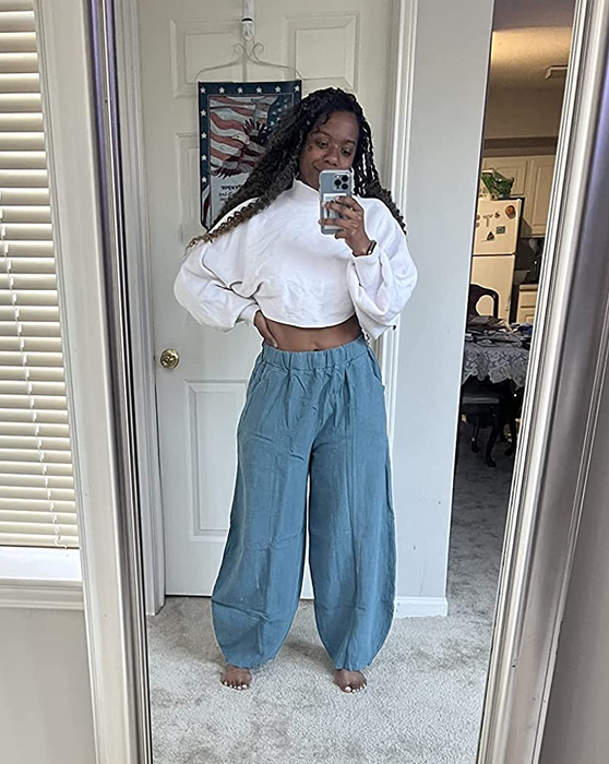 Reviewer taking a mirror selfie in blue harem pants