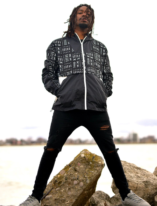 The same model showcases the windbreaker in the black and white Mud Black design.