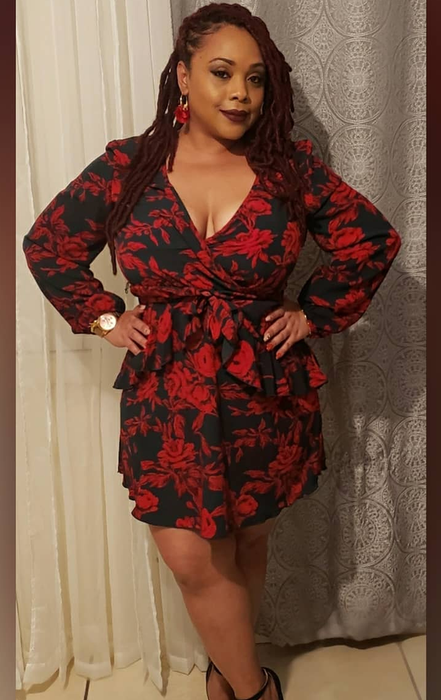 A reviewer in a beautiful floral dress