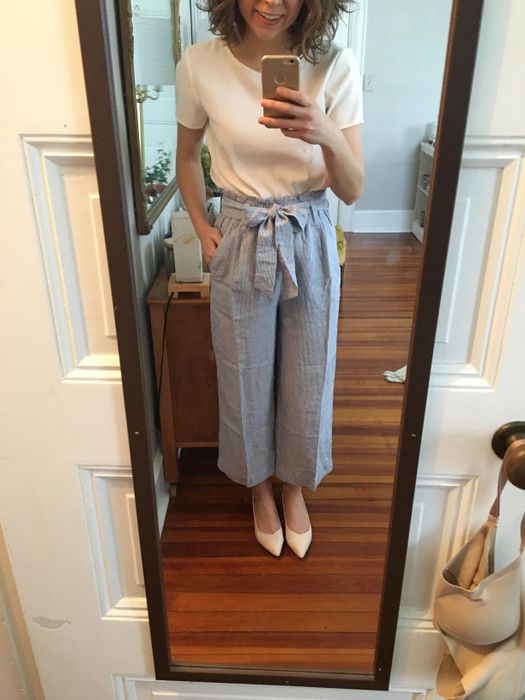 Reviewer taking a mirror selfie in blue paperbag pants