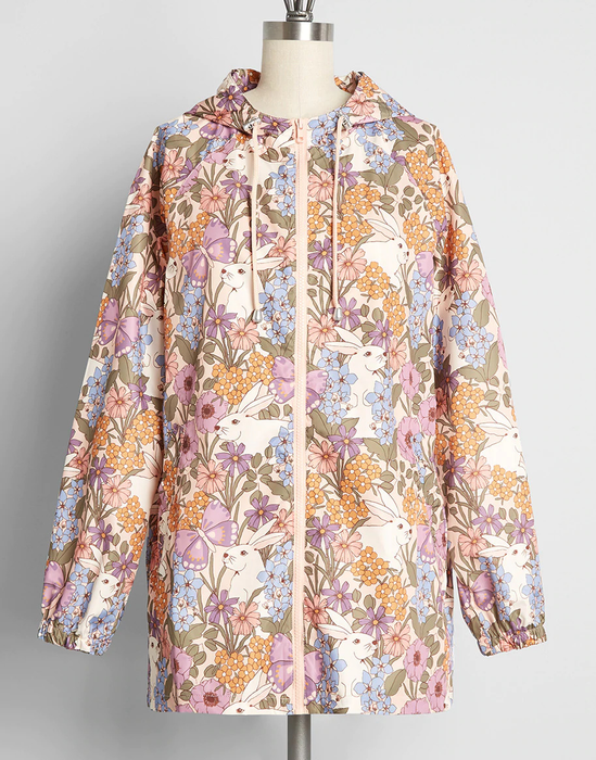 A pastel raincoat adorned with delicate florals and playful bunnies, perfect for brightening rainy days.