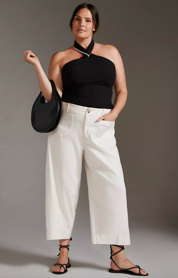 Model wearing white pants