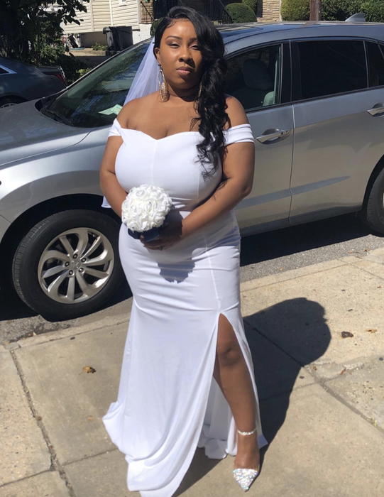 reviewer wearing the off-shoulder white dress