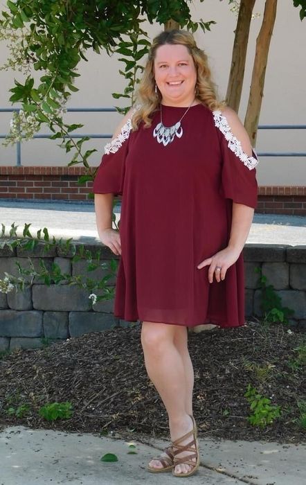 Reviewer wearing a burgundy dress.