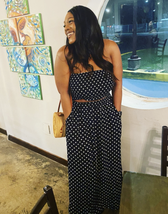 A reviewer is wearing the black and white polka dot set.