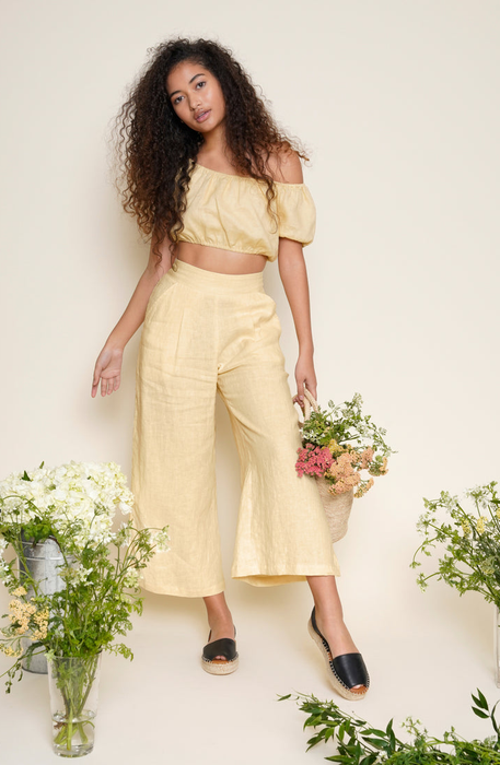 Model in yellow linen pants with a matching top