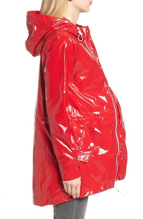 side view of the model with the maternity extender panel in place, designed to accommodate a growing belly