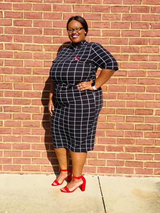 Reviewer in a black and white striped dress.