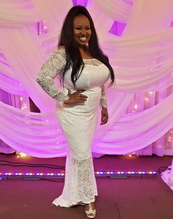 reviewer wearing the white and lace dress