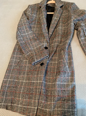 Reviewer image of the coat hanging on a hanger