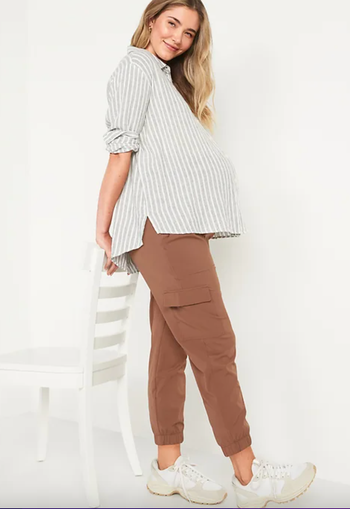 pregnant model wearing a blouse paired with brown cargo pants