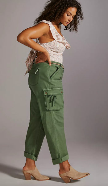Side view of model wearing green utility pants