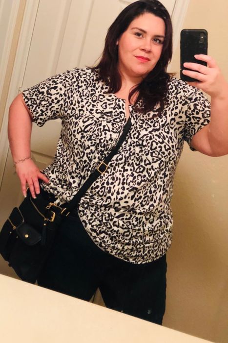 A reviewer showcasing the tunic in a stylish leopard print