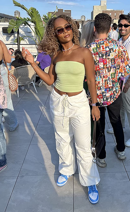 Reviewer photo wearing low-rise white cargo pants at an outdoor party