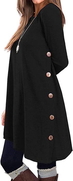 A model showcasing a black tunic with buttons down the sides