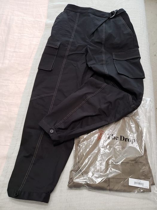 Reviewer's photo featuring the pants along with the packaging