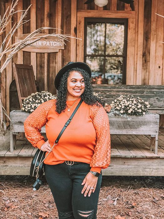 Customer wearing the top in a vibrant orange shade