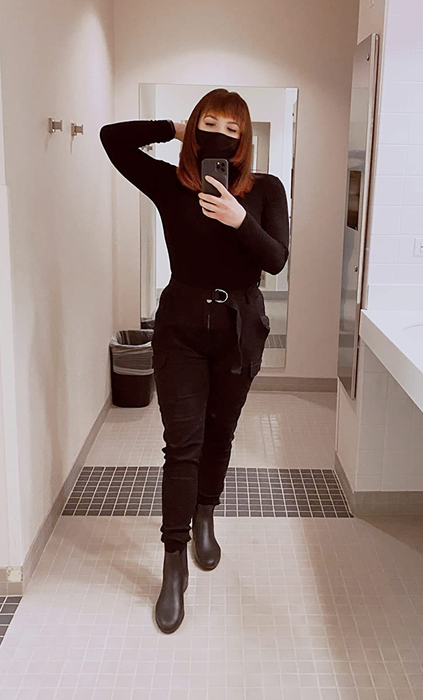 Reviewer mirror selfie wearing black belted cargo pants, styled in an all-black outfit