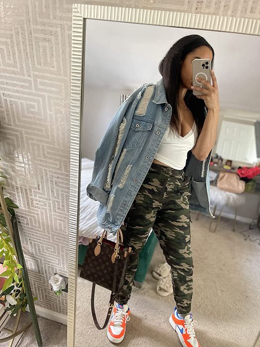 Reviewer mirror selfie wearing camo cargo pants, a denim jacket, and a baseball cap.