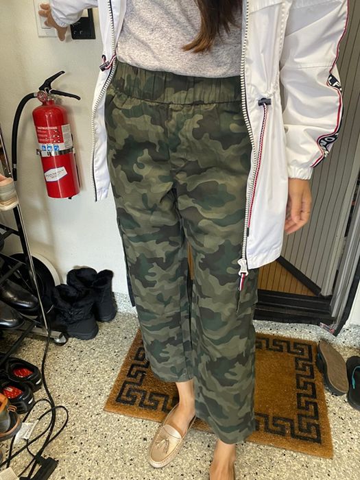 reviewer showcasing camo print cargo pants