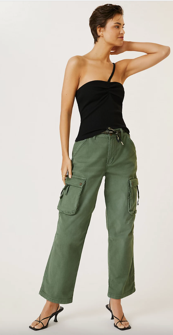 Model showcasing utility pants in green