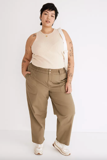 Model showcasing the pants in a greenish taupe shade