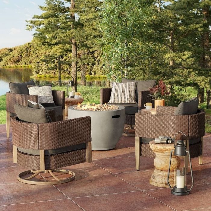 The fire pit surrounded by four patio chairs, creating the perfect outdoor setup.