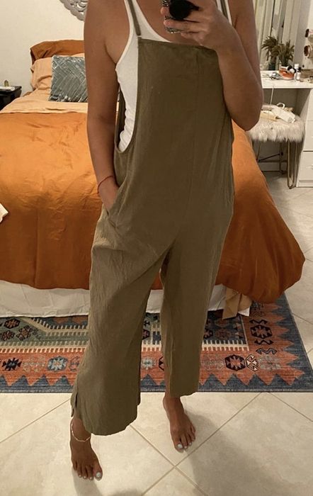 A reviewer wearing olive green overalls