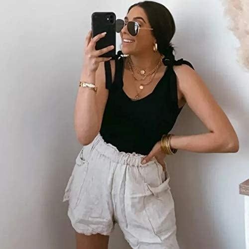 A model dons a black tank top with shorts.