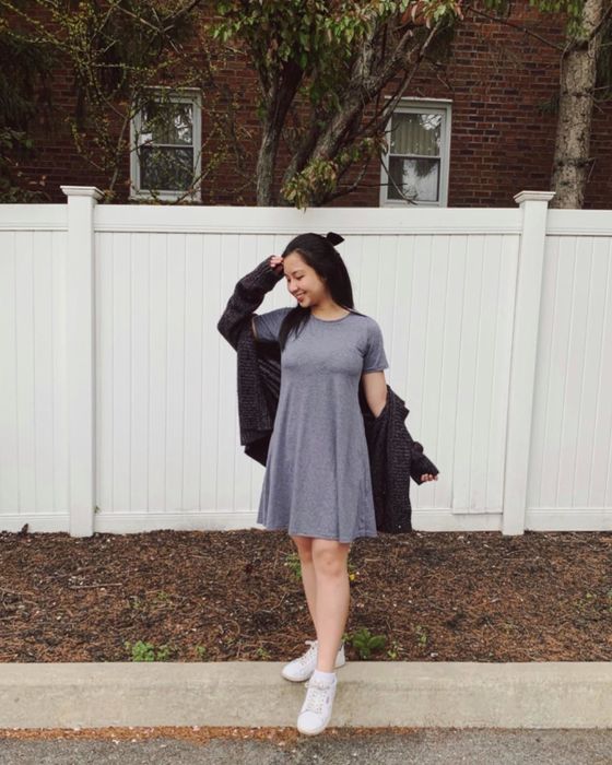 A reviewer wears a cute T-shirt dress paired with a cardigan.