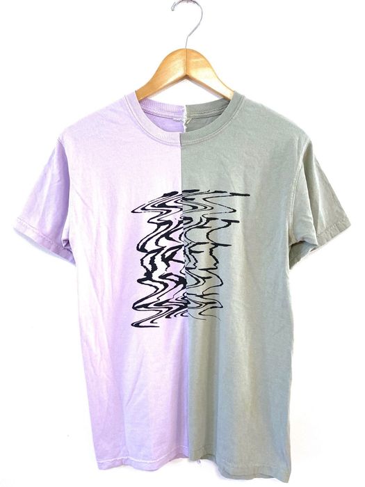 A split shirt featuring green and purple hues with a bold black graphic on the front reading 'Drift'.