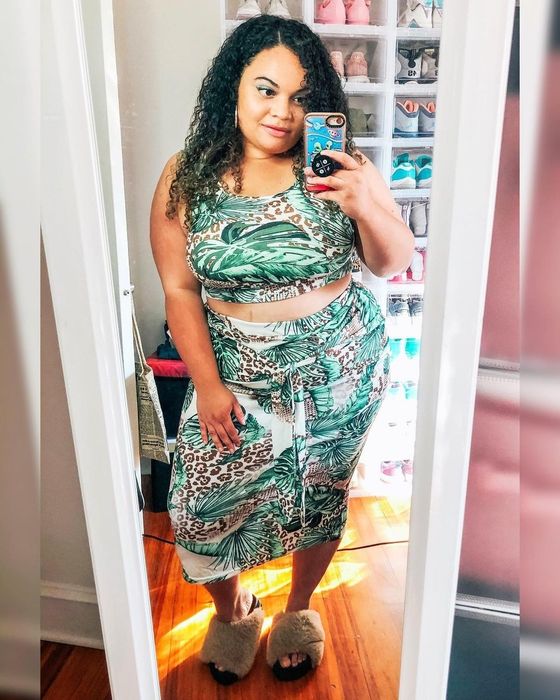Mytour editor models the two-piece set featuring a green and brown jungle print.