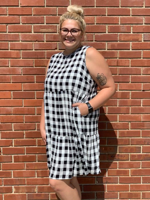 A reviewer wearing the black and white gingham dress for a classic, stylish look.