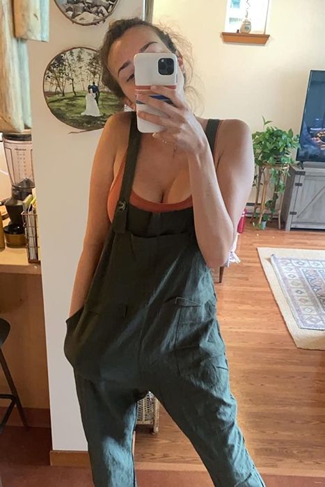 A reviewer sporting the overalls in a fresh green shade.