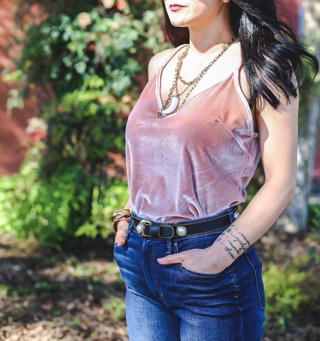 Reviewer wearing the light pink cami with jeans