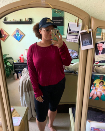 Reviewer pairs black leggings with a red long-sleeve top featuring a keyhole design at the back