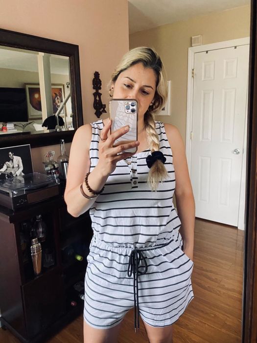 Reviewer wearing the white striped romper.