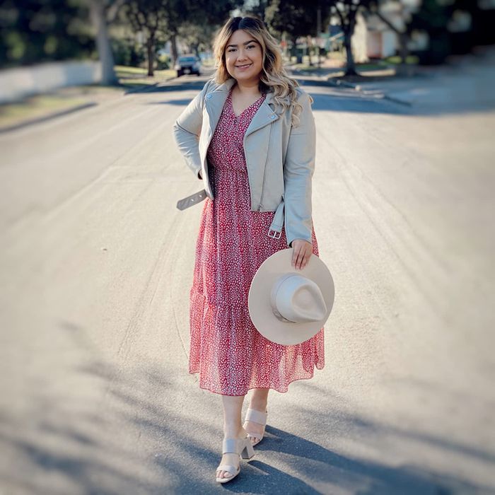 Another reviewer showcasing a pink and white dress, paired with a gray leather jacket and white heels for a bold yet stylish look.