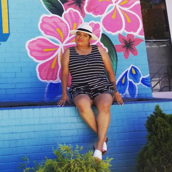 Reviewer wearing the black striped romper.